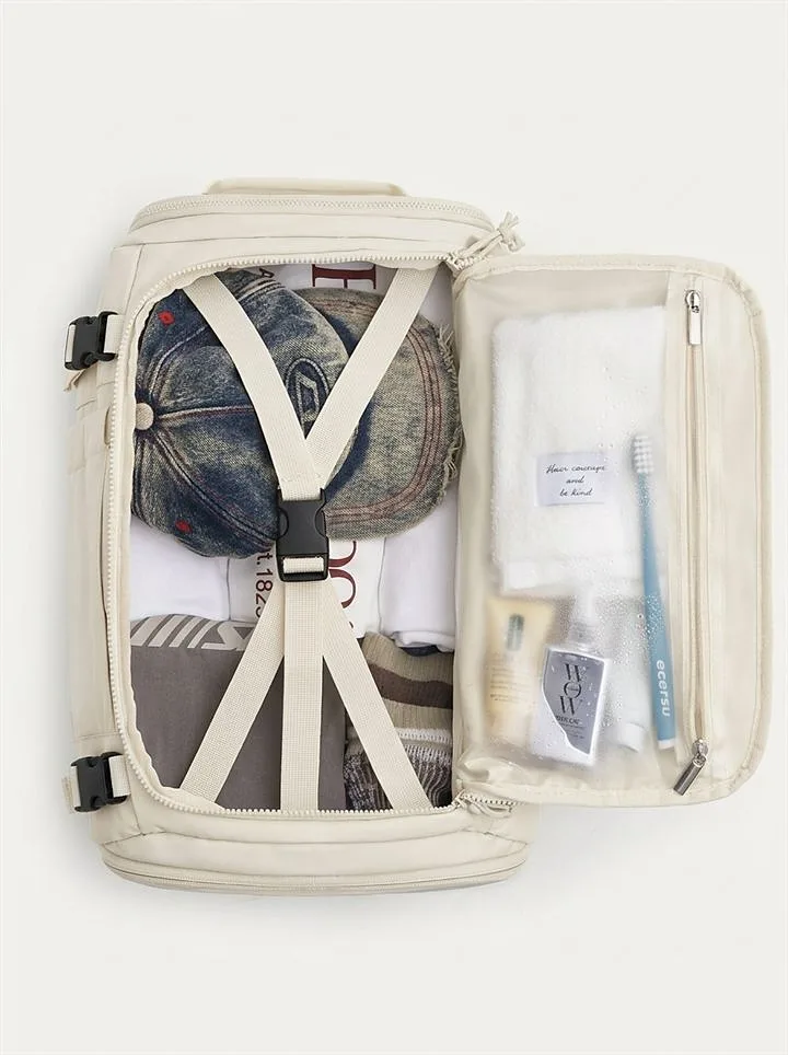Main compartment opened with compression straps and clear toiletry pouch